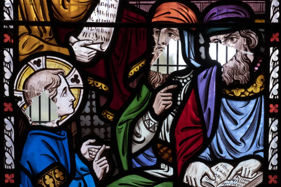 Stunning multicoloured stained glass showing the result of vandalism and damage.