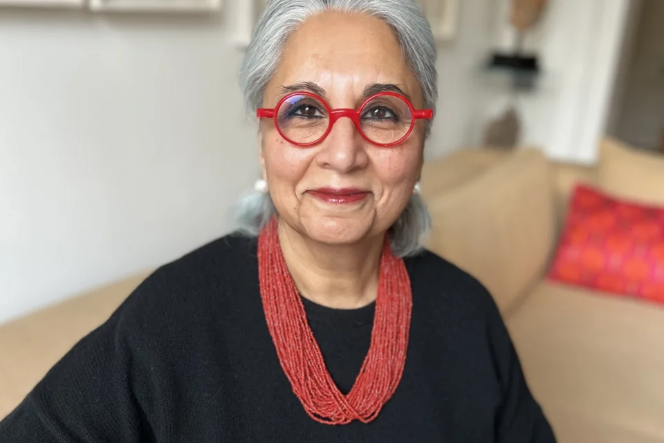 portrait photo of Tanvir wearing red beads and red glasses