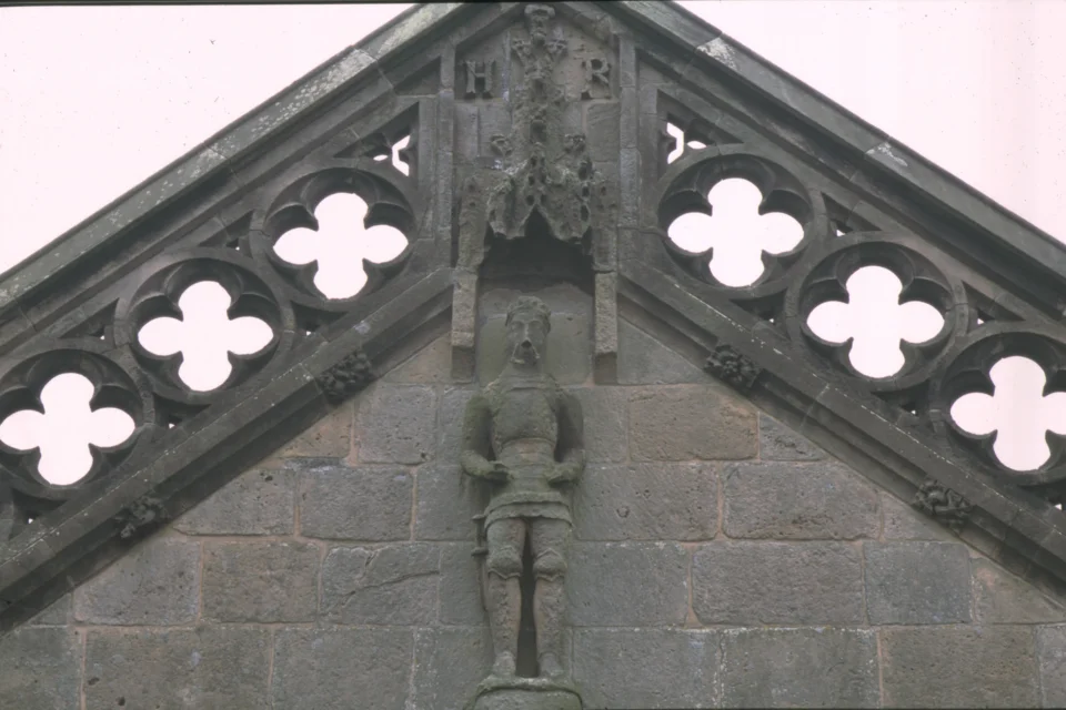 Stone small statue of Henry IV on outside east wall with H R and his crest above him.