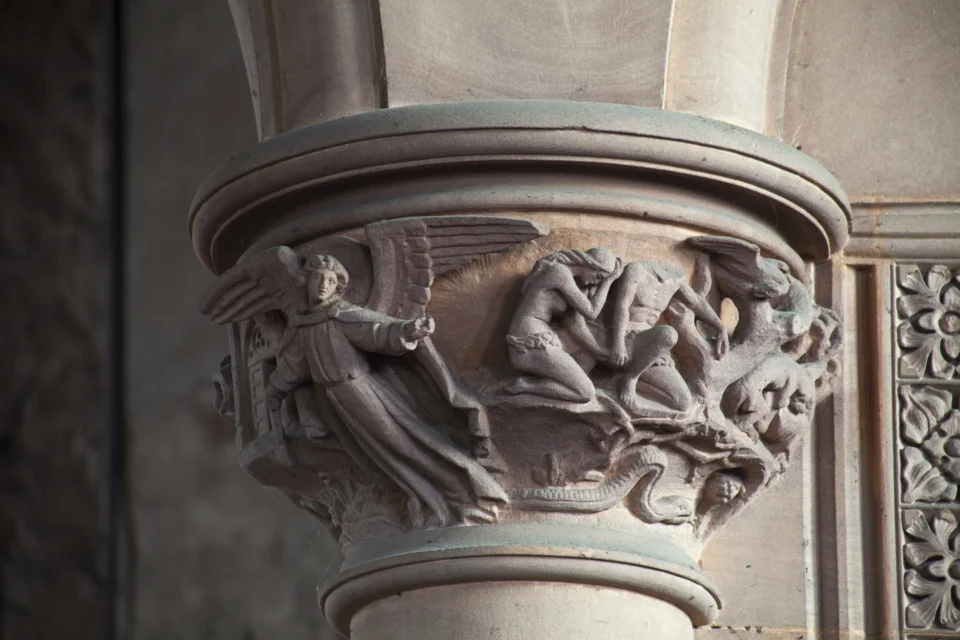 Ornate stone carving showing angel and women around the column