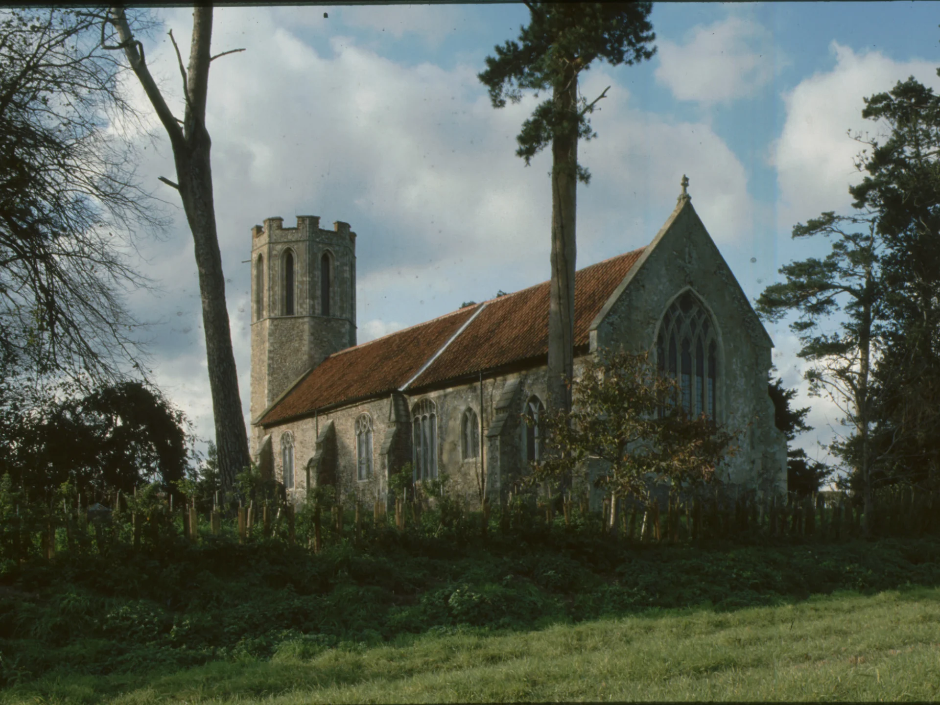 Exterior with thirteenth-century octagonal tower sits peacefully surrounded by trees