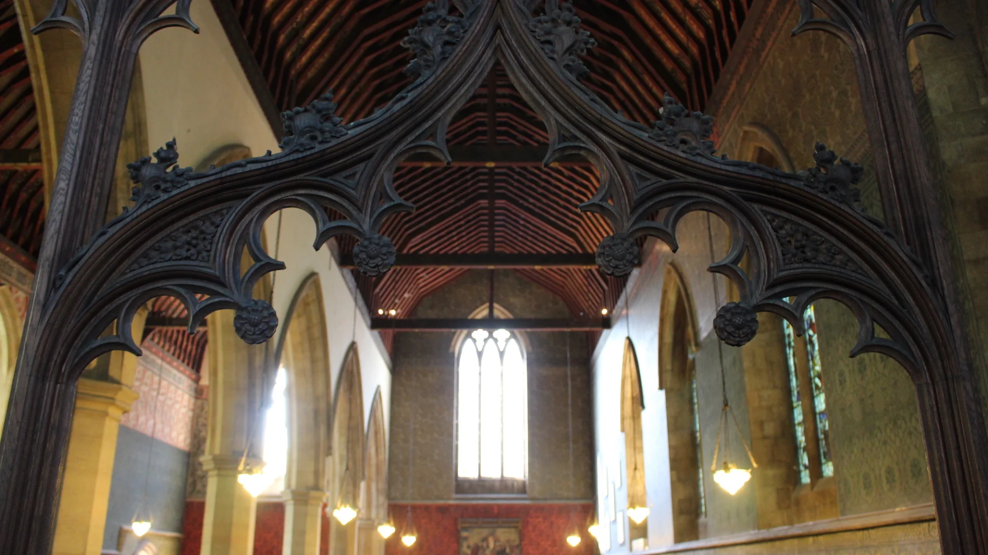 Decorative Victorian Internal Archway through which are the archways and tall windows of the interior.
