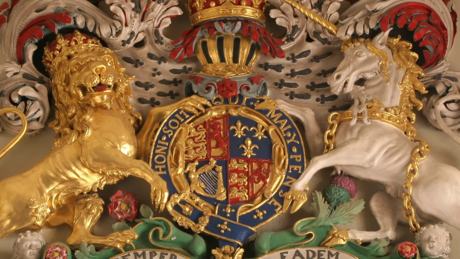 beautifully painted royal coat of arms with vibrant reds, blues and golds