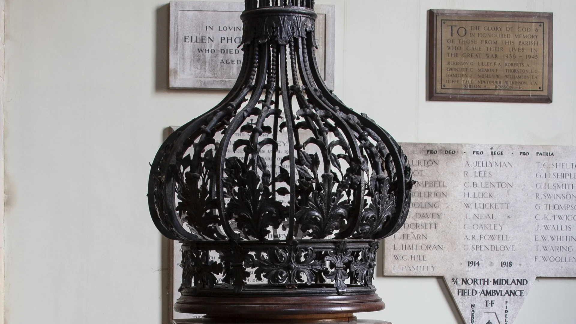 tall iron font cover forming a bulb shape with bent iron rods