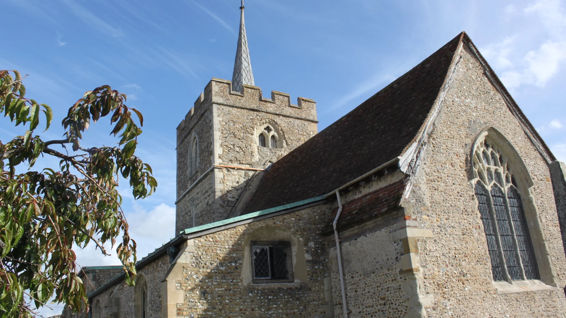 Church exterior with lead 'spike' rising from the tower