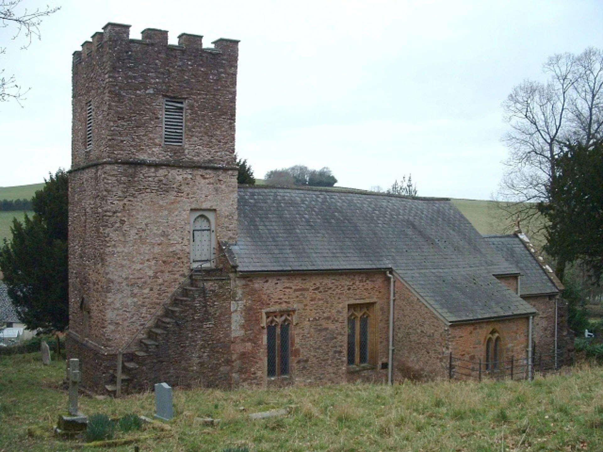 This thirteenth-century church has a distinctive battlemented tower with an unusual outside stairway.