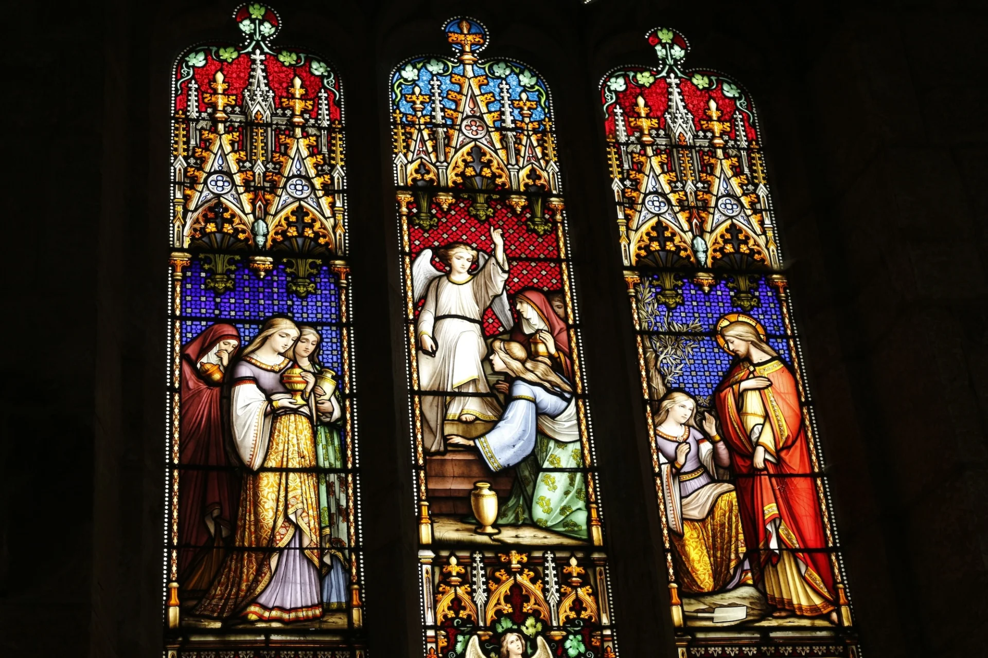 brightly coloured red, blue, light blue and gold showing figures including Jesus and an angel