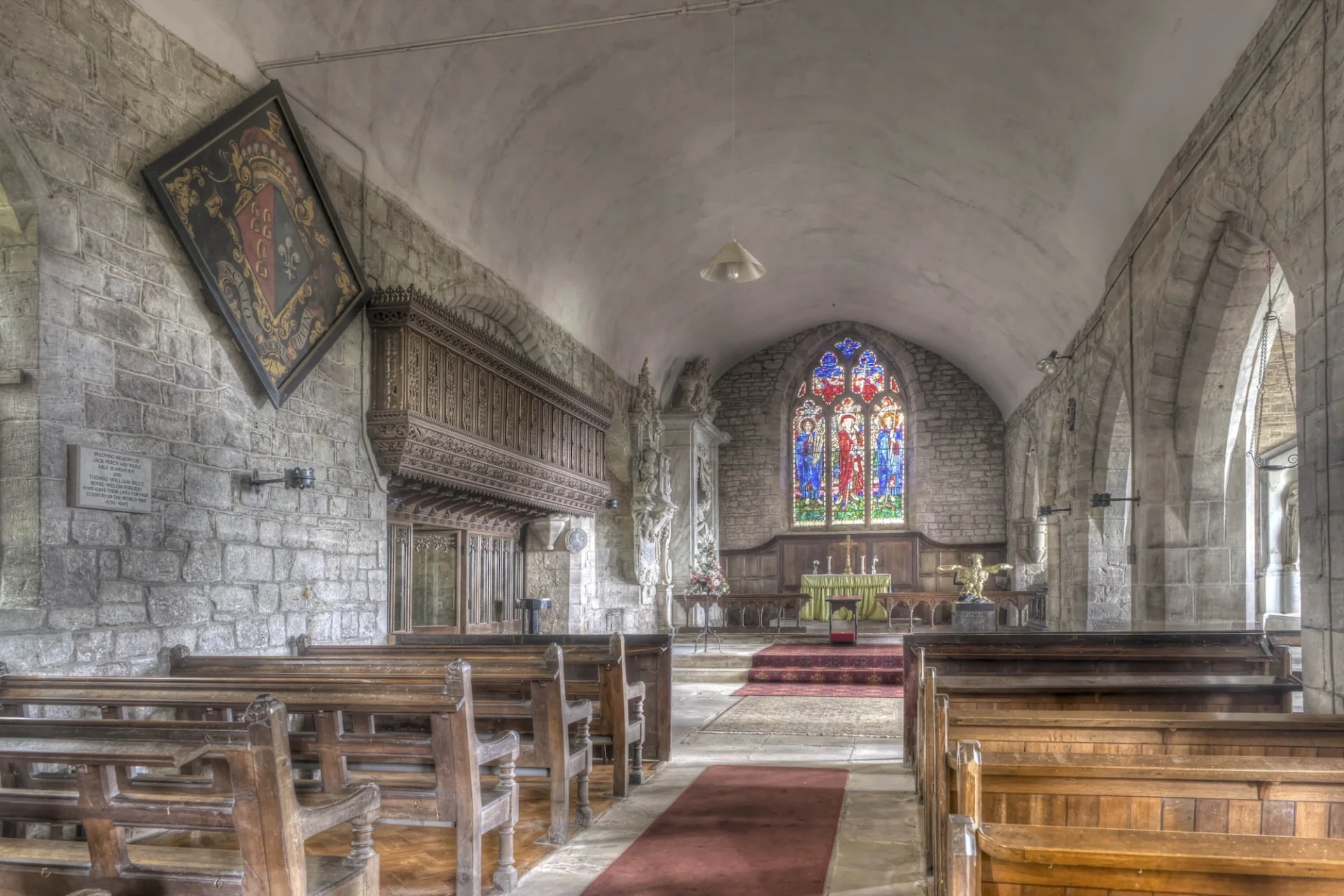 nave with beautiful stained glass and glimpses of wall monuments