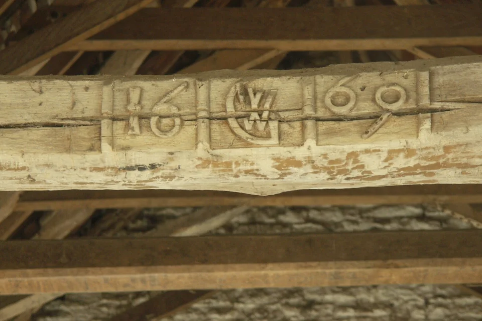 Part of the roof structure with the year 1669 carved on it