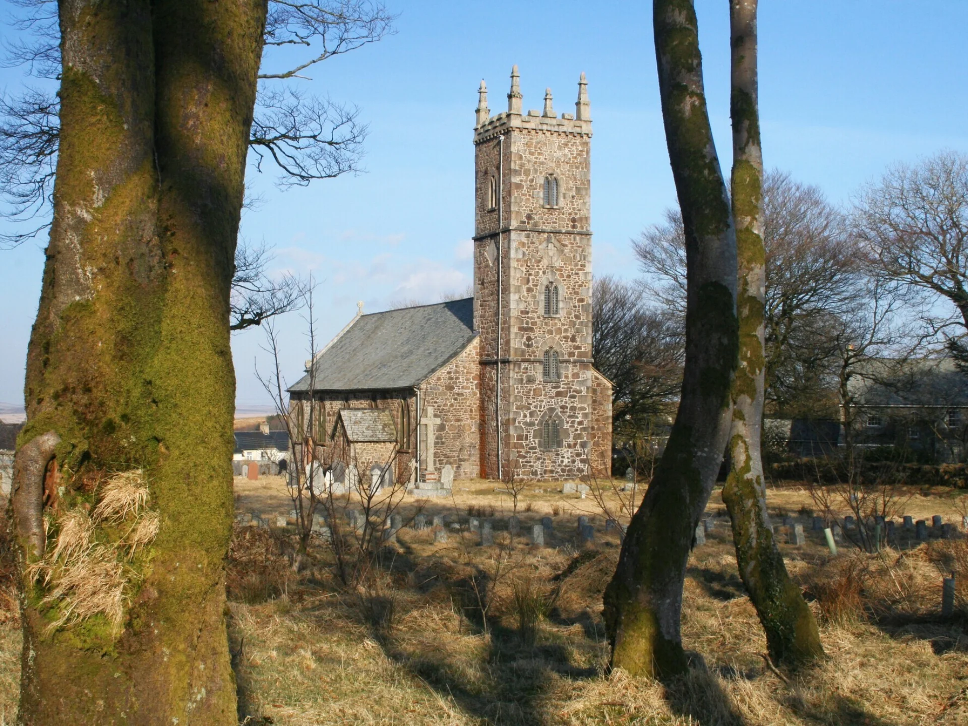External view of the stone built church through the trees