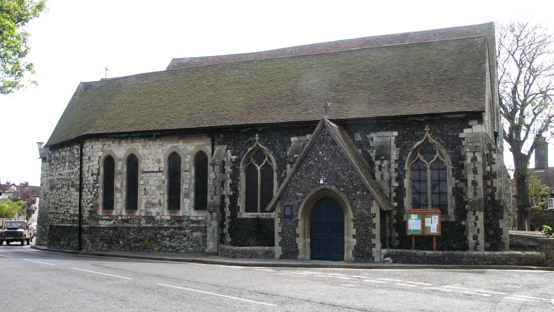 View of the side of the sone built church with flint walls