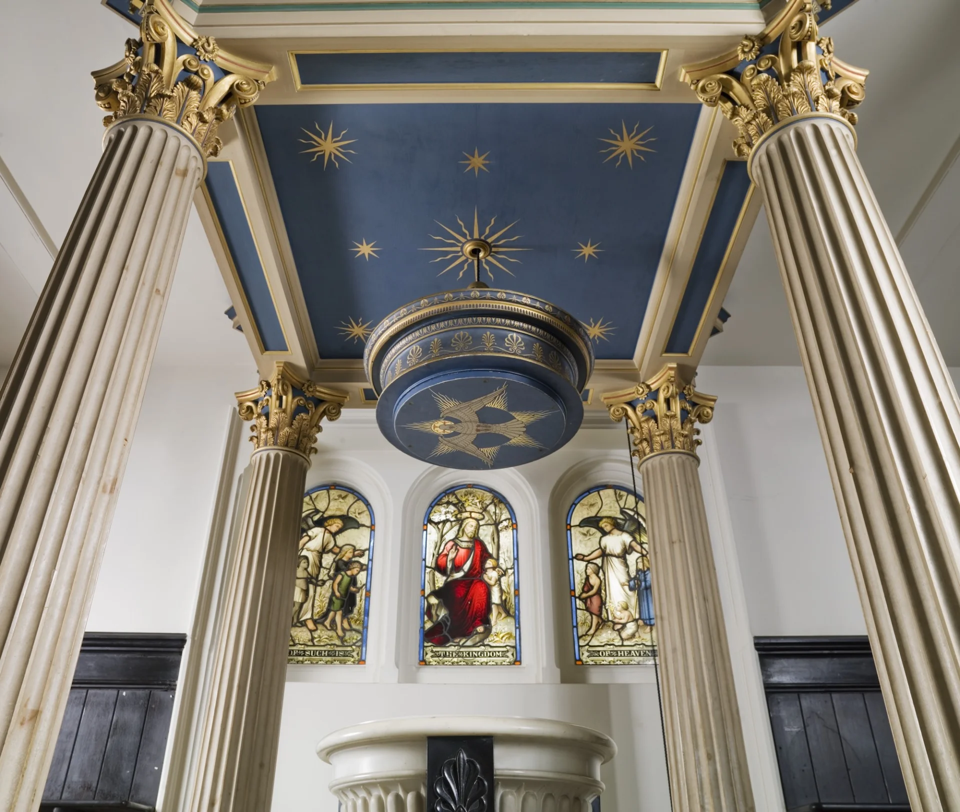 beautiful painted ceiling features the sun surrounded by a crescent moon, a comet, Saturn and stars.