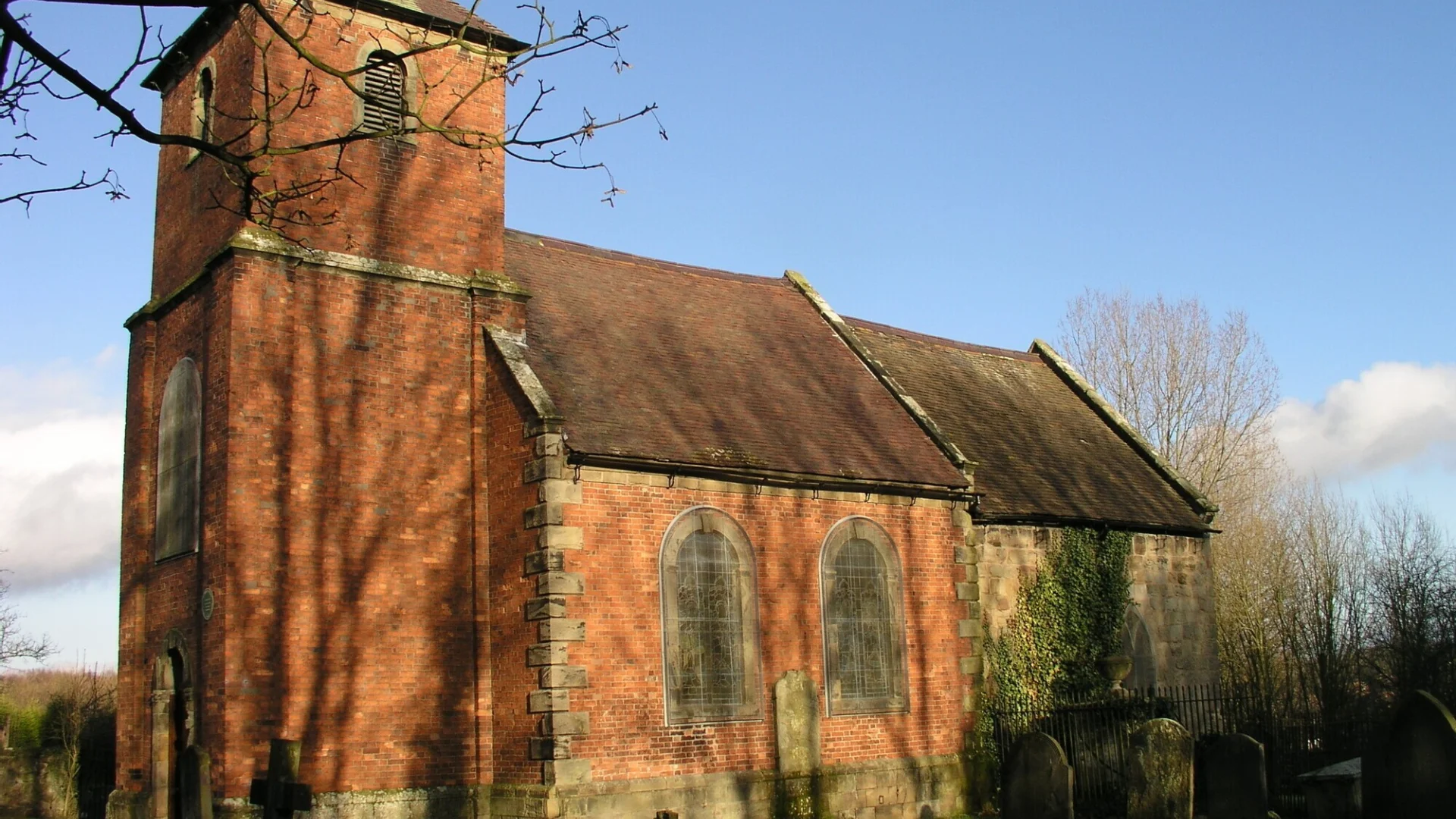 Exterior of the red brick built church and tower