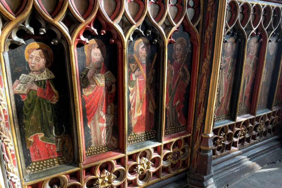Decorated panel with wood carving and paintings of religious figures