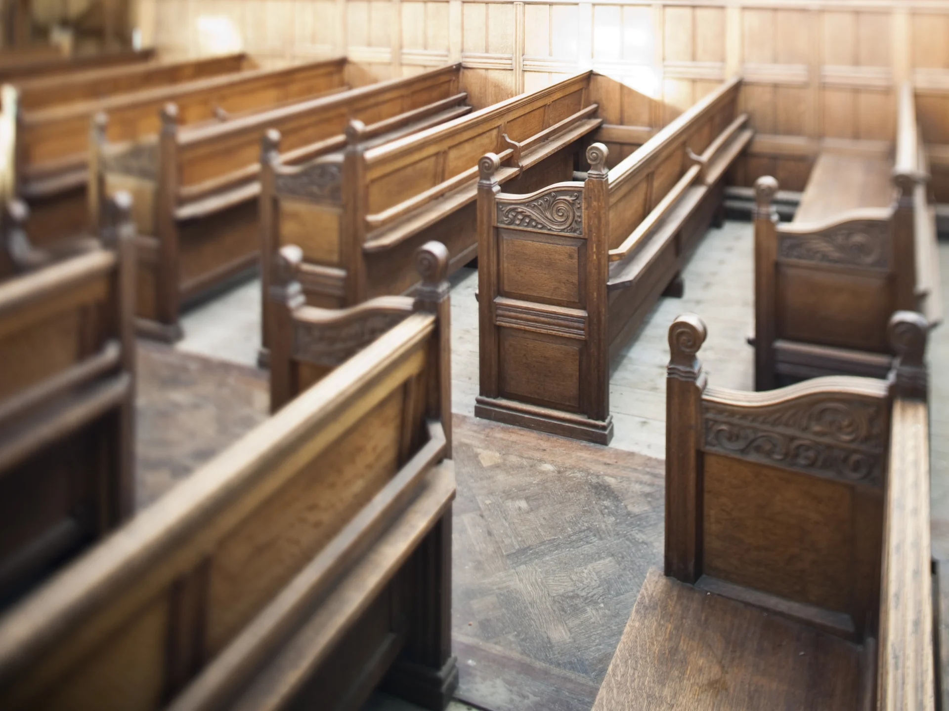 Image of wooden pews with carved decoration on its sides