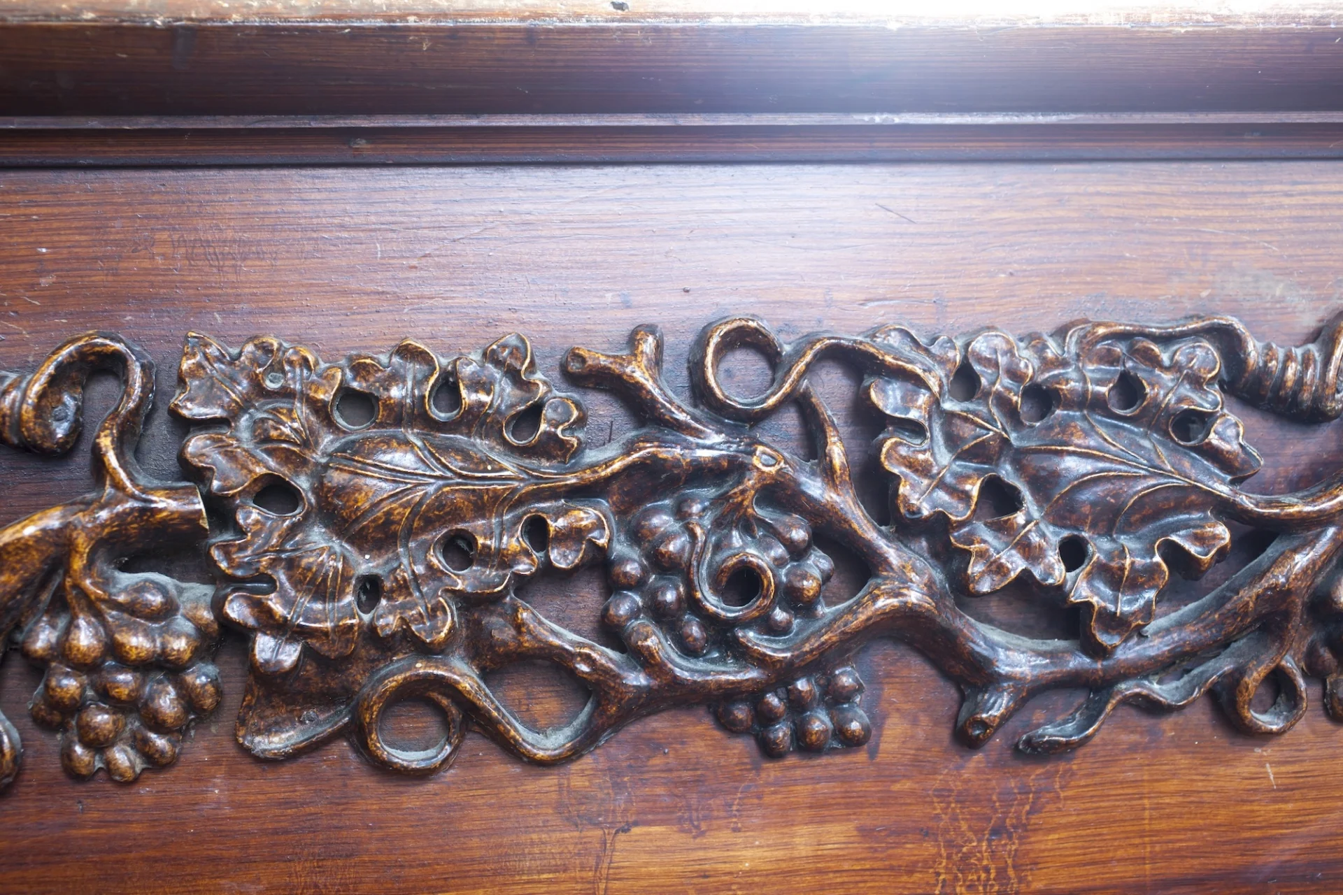 pews with intricately carved vines and grapes