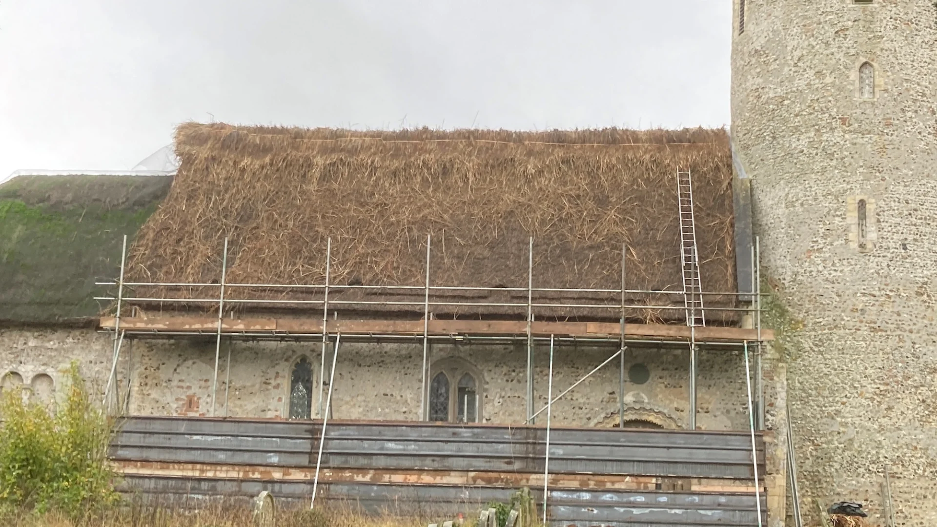 St Margarets Church Hales with thatched roof in scafolding with new thatched laid.