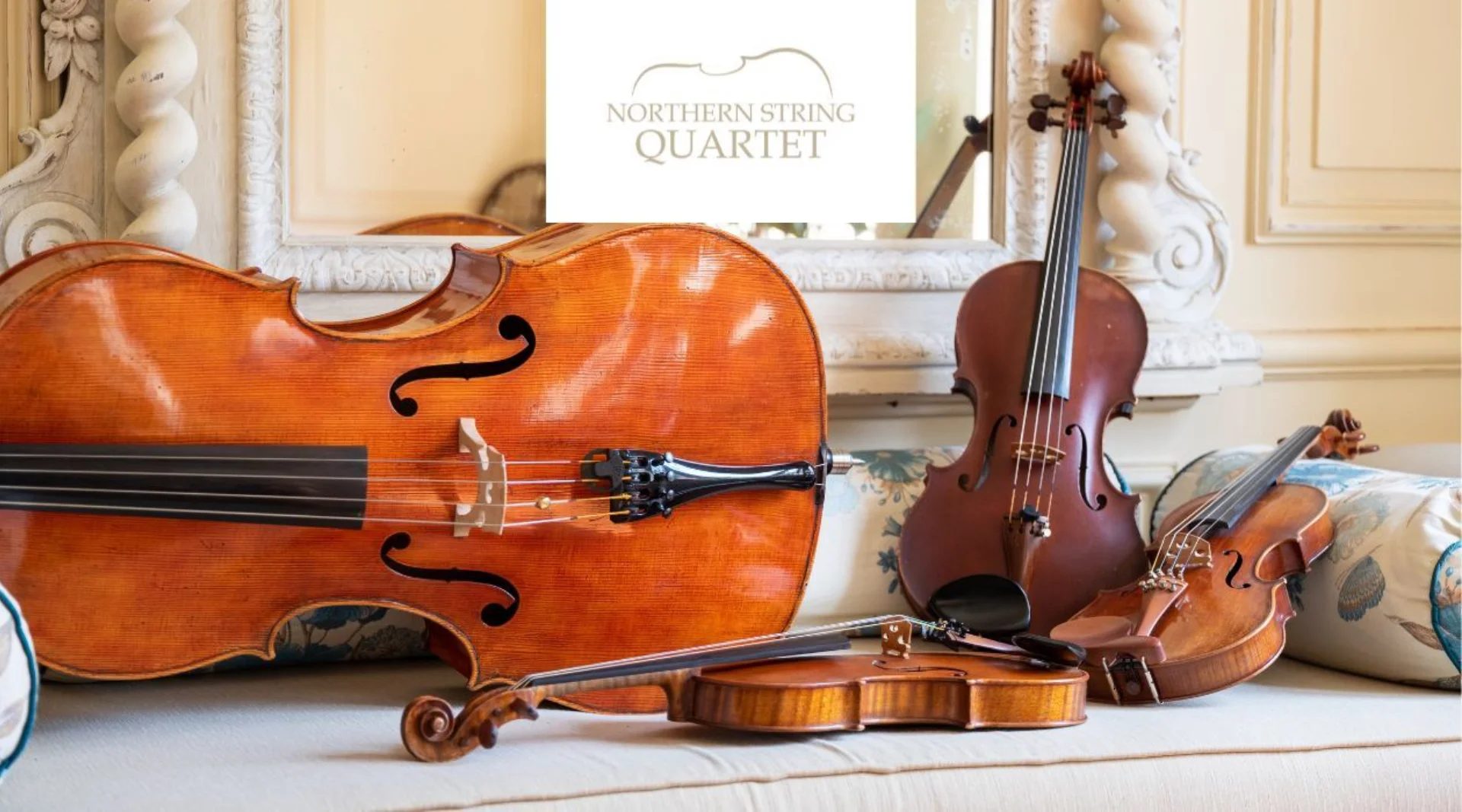 violins and cellos leant on the mantle in front of a mirror with the logo for the Northern String Quartet