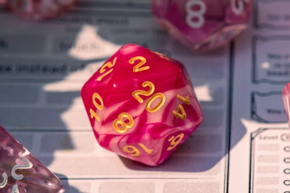 Image of d20 (20 sided dice) on a character sheet for the game dungeons and dragons