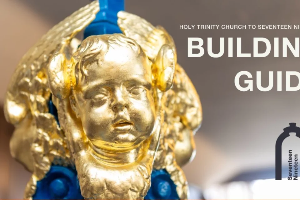 golden faces of cherubs at the base of a thin wooden column