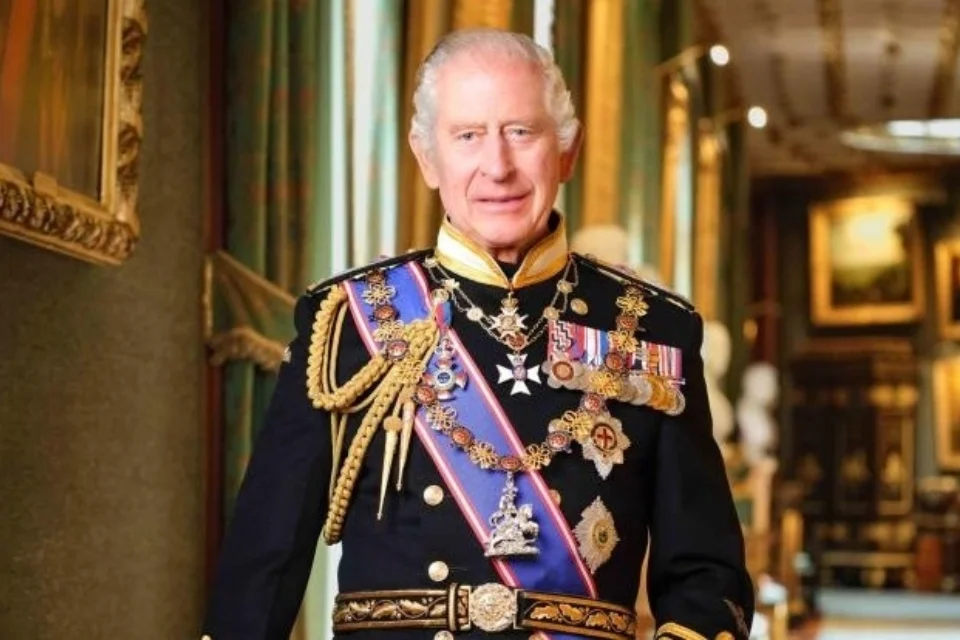 King Charles III in black jacket covered in medals