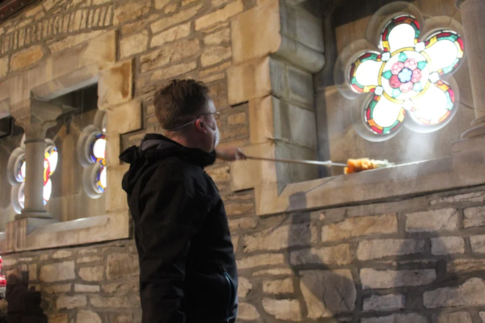 A volunteer helping to clean one of CCT's churches