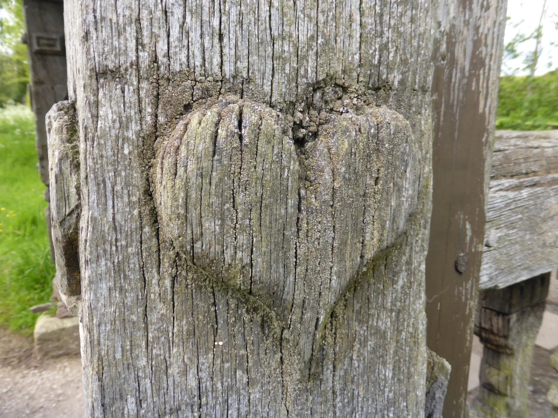 Carved heart in wooden post