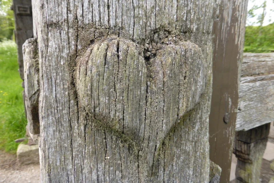 Carved heart in wooden post