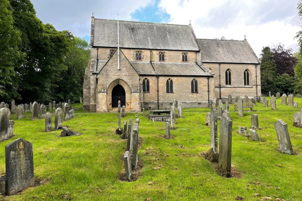small church exterior in green graveyard